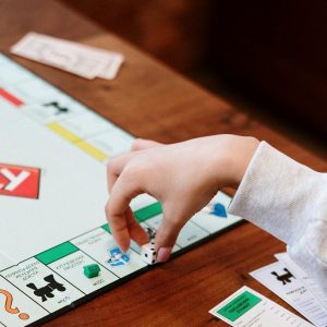 Monopoly Board Game on Brown Wooden Table